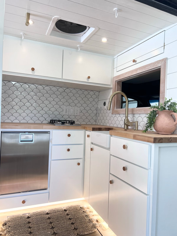 Custom crafted camper van with farmhouse sink